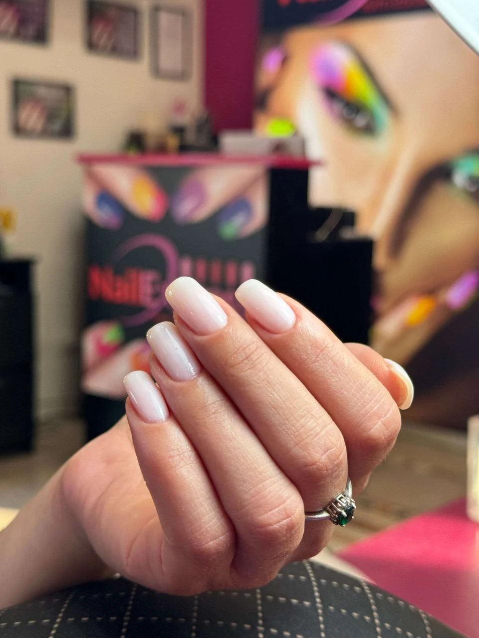 Manicure bianca con il salone Nail Express Firenze sullo sfondo